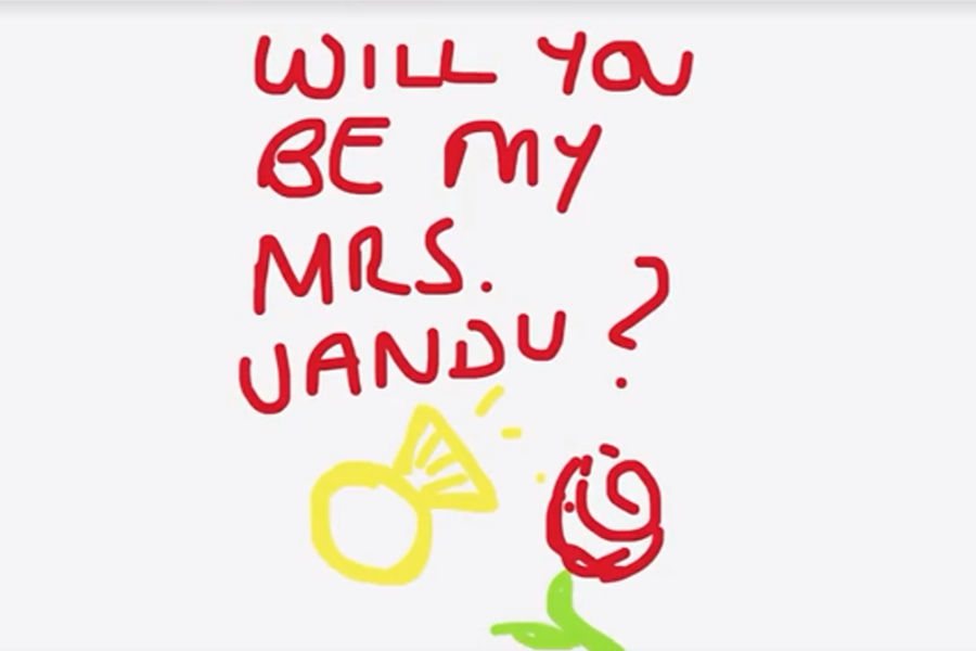  A handwritten digital proposal reads “Will you be my Mrs. Jandu?” in red text, accompanied by a simple drawing of a yellow engagement ring and a red rose with a green stem.