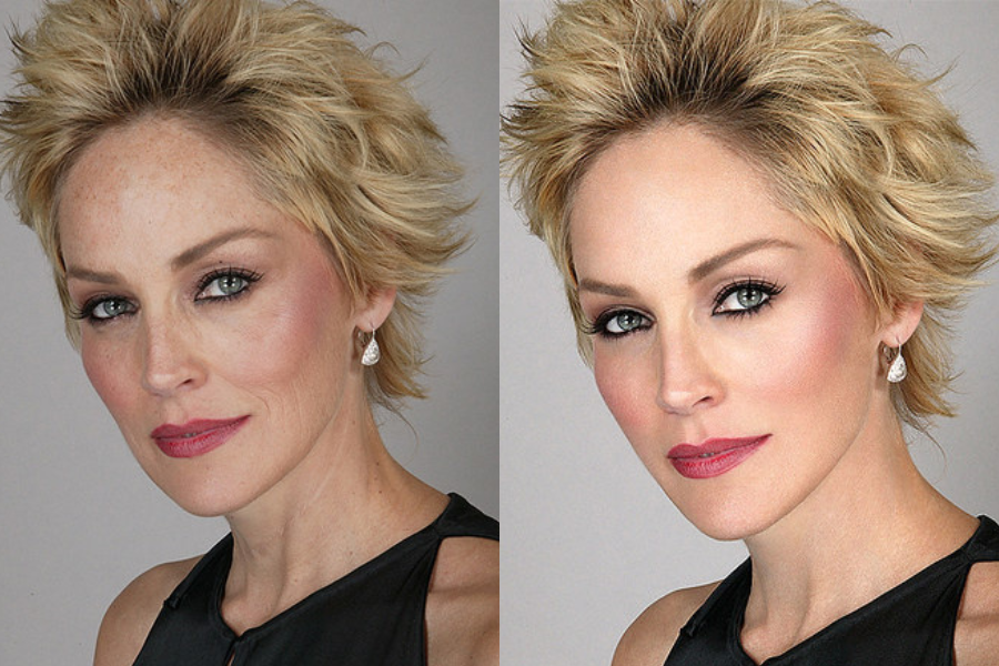 Side-by-side close-up portraits of a woman with short, tousled blonde hair, wearing a black top and drop earrings. The left image shows natural skin with visible freckles and fine lines, while the right image presents a retouched version with flawless, smooth skin and enhanced makeup definition.